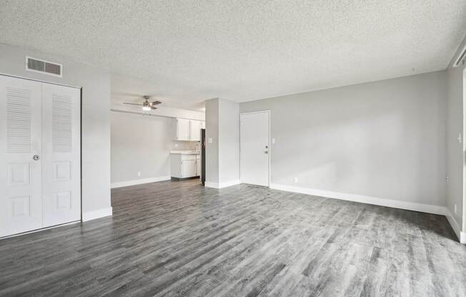 A room with a wooden floor and white walls.