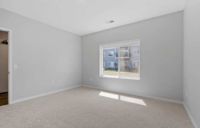 a bedroom with a large window at The Lodge at Overland, Rochester, MN