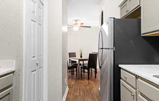 our apartments offer a kitchen and dining room with a black refrigerator