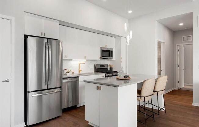 modern apartment  kitchen with island and stainless steel appliances
