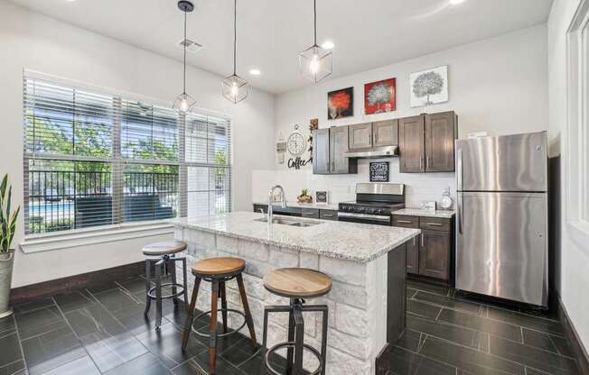 A kitchen with a white countertop and a stainless steel refrigerator.