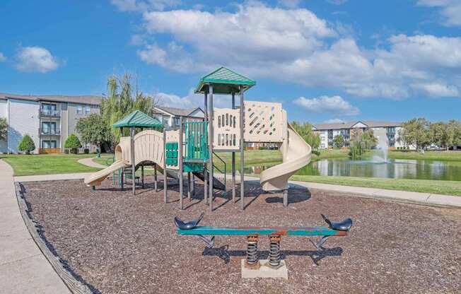 Onsite playground with a seesaw and a slide at Ultris Island Park in Shreveport, LA