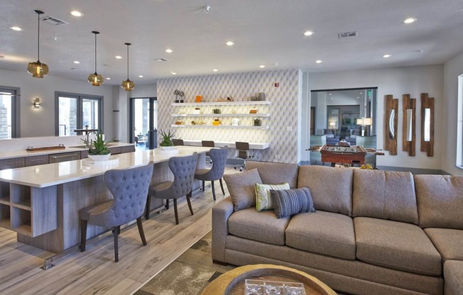 a living room with a couch and a bar and a kitchenat Creekside at Legacy, TX 75024