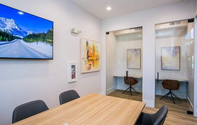 A conference room with a large table and chairs.