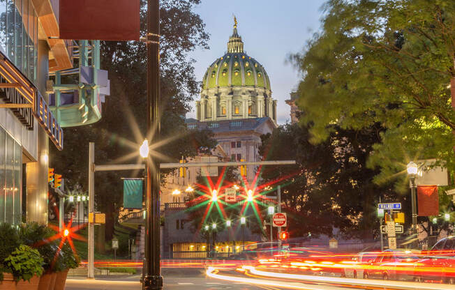 a city street at night with the capitol building in the background