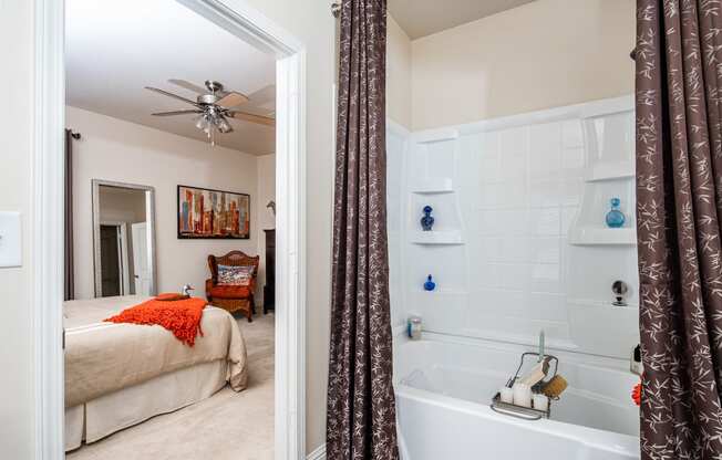 Bathroom with ceramic tub/shower with view of master bedroom at Riverstone apartments for rent in Macon, GA