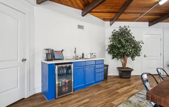 a kitchen with blue cabinets and a table and chairs