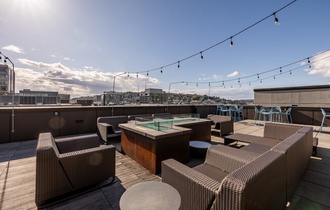 a view of the rooftop terrace with couches and tables