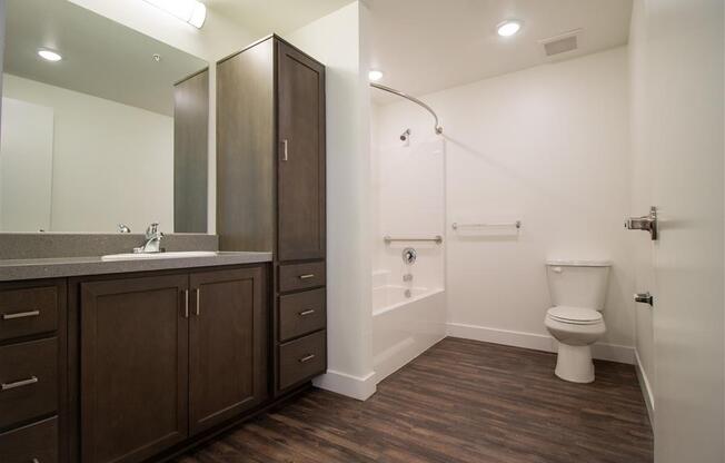 a bathroom with a toilet sink and mirror at Loma Villas Apartments, California, 92408