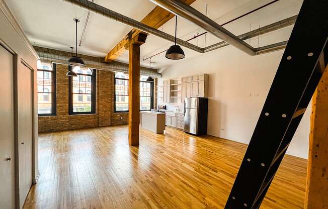A large open space with wooden floors and exposed ceiling beams.