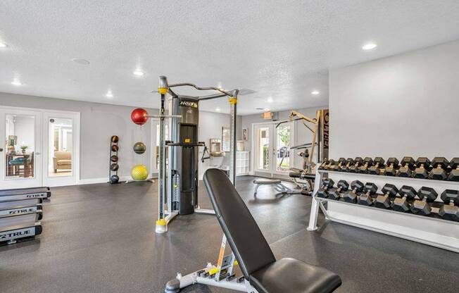 Free weights in the fitness center with weight bench and pulley machines