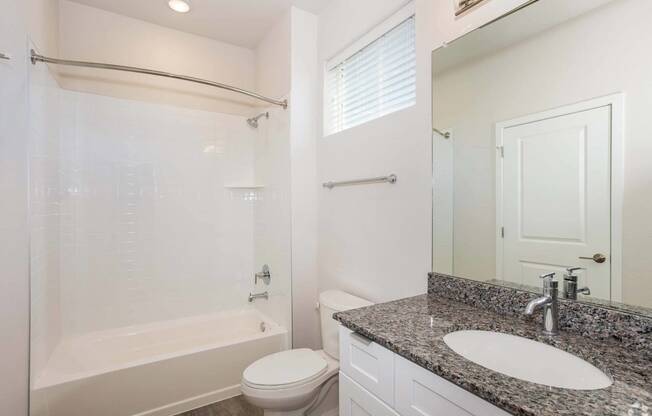 bathroom with white tub and grey sink at Brownstones at Palisade Park Townhomes, Broomfield, CO