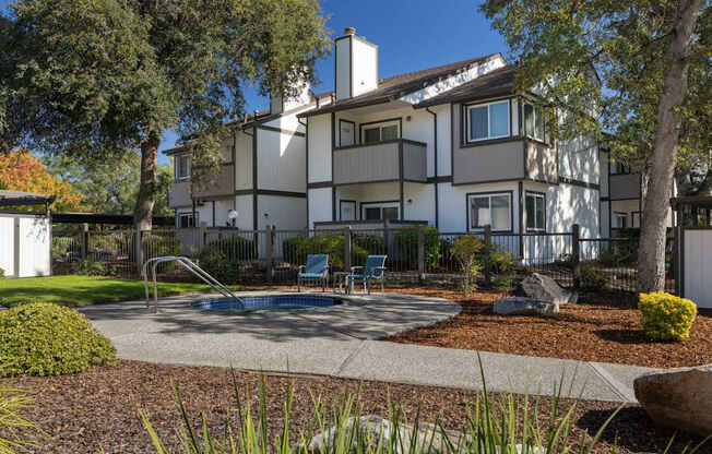 A large white house with a pool in the backyard.