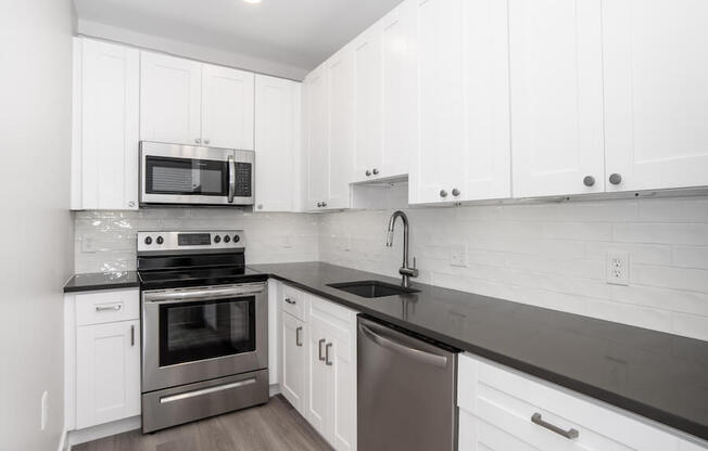 white kitchen with stainless steel appliances and white cabinets