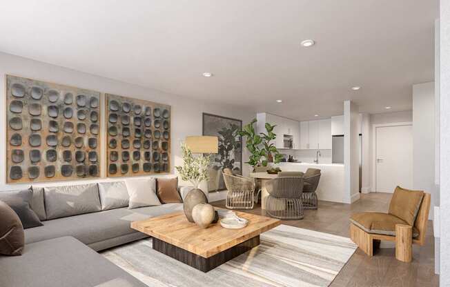 A modern living room with a grey sofa, a wooden coffee table, and a large artwork on the wall.