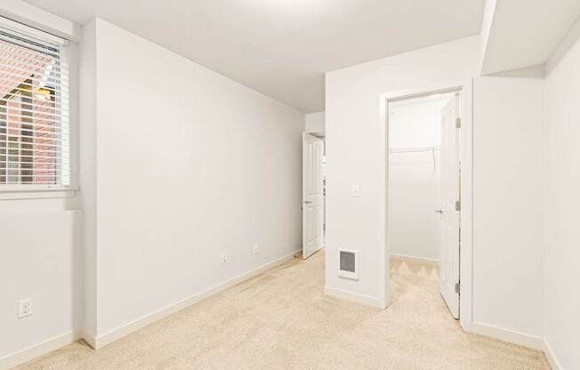 A white room with a doorway leading to another room.