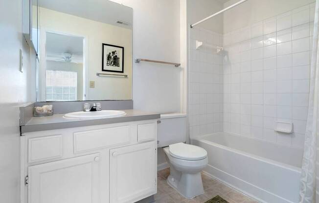 A white bathroom with a toilet, sink, and bathtub.at Camden Place, Dublin, OH