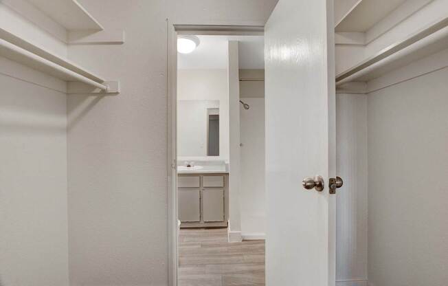 A white door is open to a kitchen.