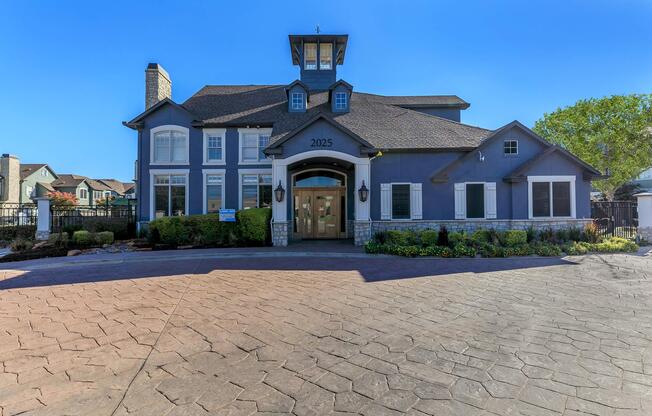 a small clock tower in front of a house