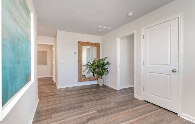 a bedroom with a large white door and a large mirror on the wall