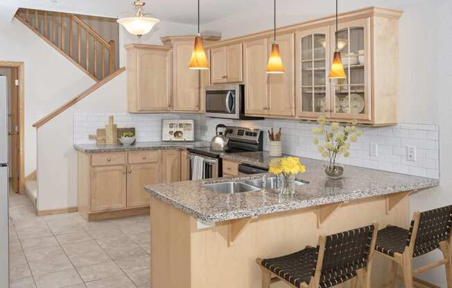 a kitchen with wooden cabinets and a granite countertop
