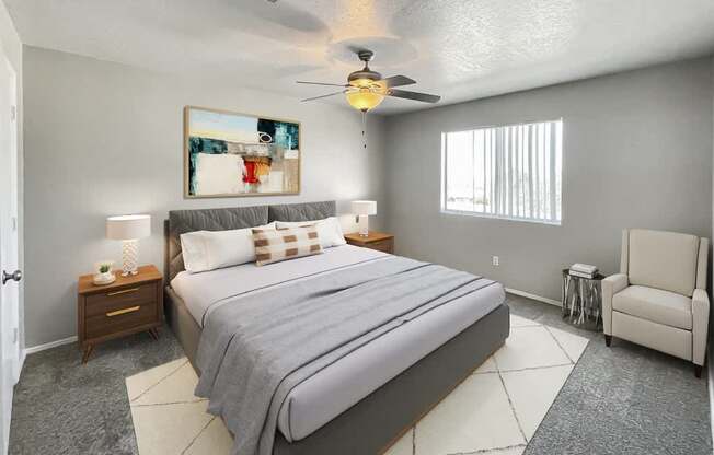 A bedroom with a large bed and a ceiling fan.