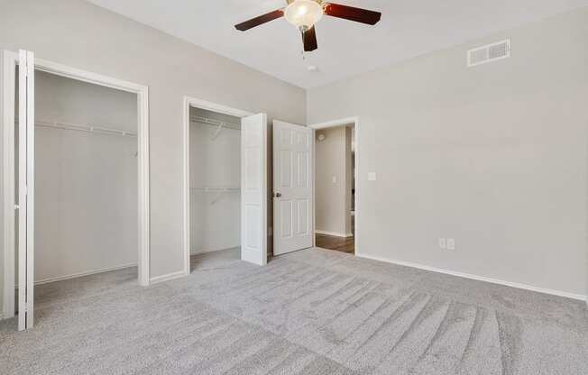 Luxury One Bedroom Apartments in Plano, TX - Carrington Park Apartments Bedroom With Ceiling Fan, Plush Carpeting and Large Closets