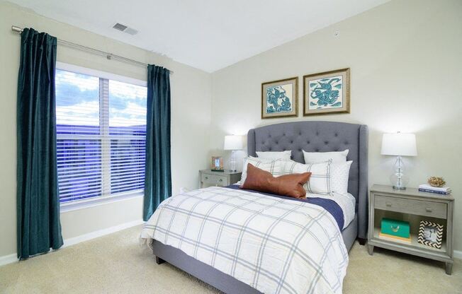 a bedroom with a large window and a bed