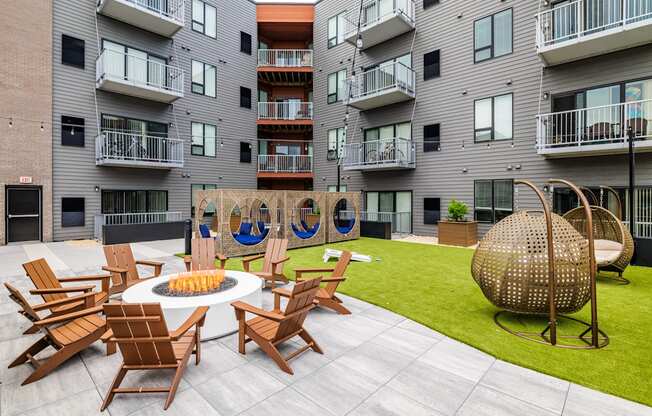 an outdoor patio with chairs and a fire pit at an apartment building at EagleRidge Plaza Residences, Fargo, 58104