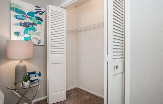 a room with a closet and a lamp