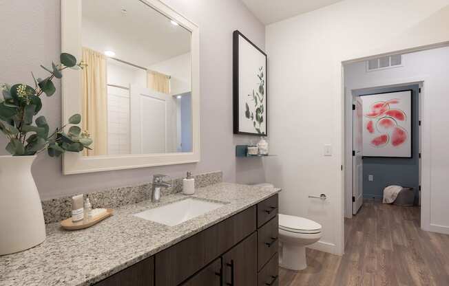 a bathroom with a toilet sink and mirror at Lake Nona Concorde