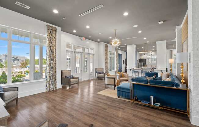 a living room with a blue couch and a large window