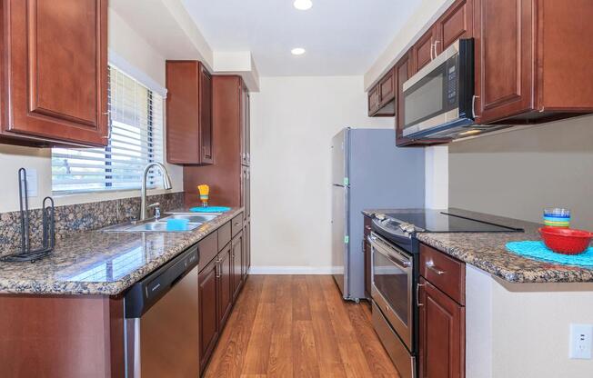 a kitchen with stainless steel appliances and wooden cabinets