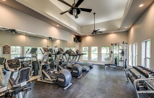 Grand Prairie Apartments for Rent - Forum at Grand Prairie - Fitness Center with Free Weights, High Ceilings, Cardio Machines, and Weight Machines