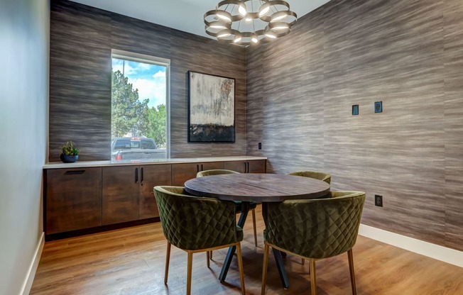 a dining room with a round table and chairs