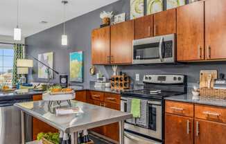 a kitchen with stainless steel appliances and wooden cabinets