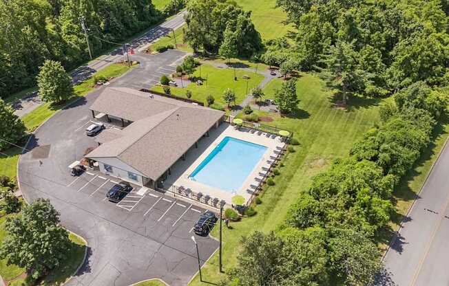 A large building with a pool in front of it.