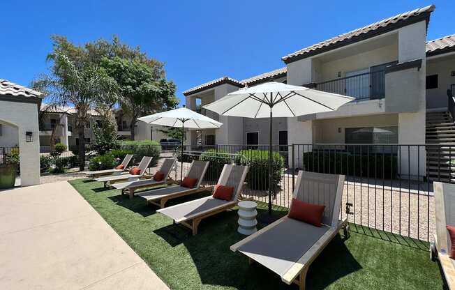 Lounge in luxury by our pool deck with plenty of comfy chairs for ultimate relaxation at Boulders at Lookout Mountain Apartment Homes, Phoenix, AZ 85022
