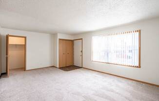 A room with two doors and a window with blinds. West Fargo, ND Sheyenne Terrace Townhomes