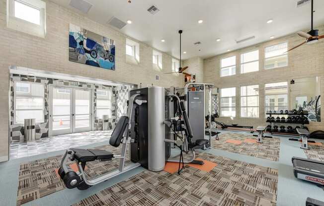 Fitness Center with Excercise Bikes, Ellipticals, Ceiling Fan and Patterned Rug at Morgan Ranch Apartments, Morgan Hill, CA, 95037