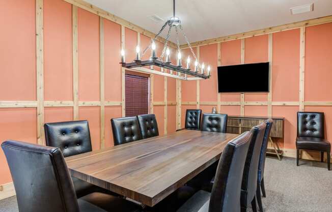 accommodation type with a large wooden table and black leather chairs