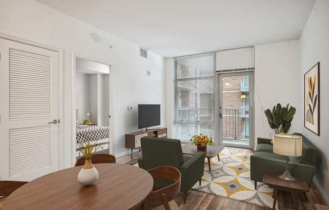 a living room with a table and chairs and a tv
