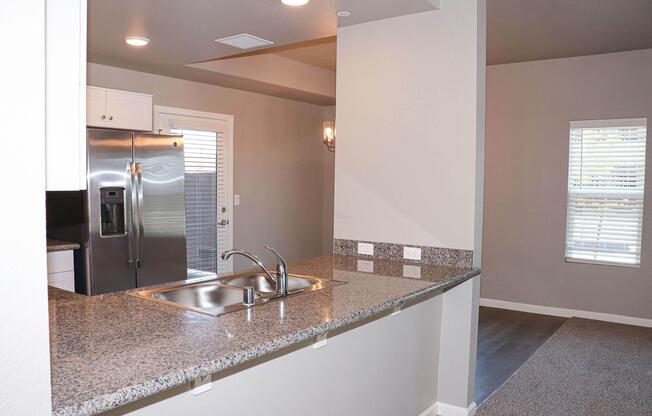 a kitchen with a sink and a mirror