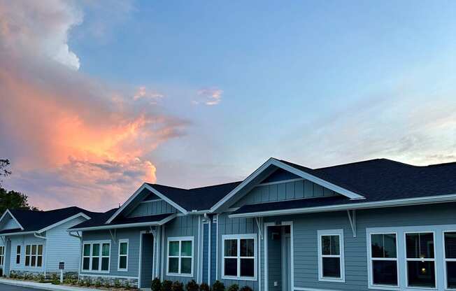 a blue house with a sunset in the background  at The Sophia, Venice, Florida