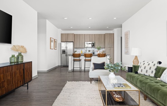 a living room with a couch and a coffee table in front of a kitchen at Palm Grove in Ellenton, FL 34222