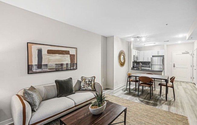 the living room of an apartment with a couch and a table