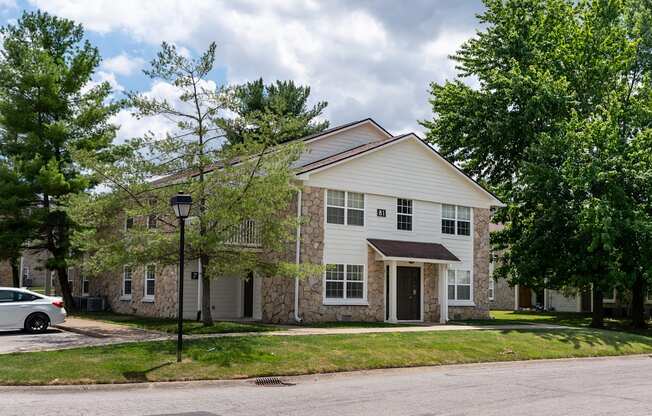 a white house with a car parked in front of it