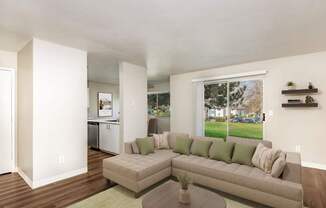 A living room with a couch, a coffee table, and a window.