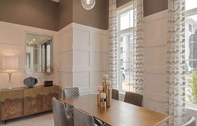 A dining room with a wooden table and grey chairs.