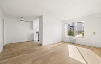 A room with wooden floors and white walls.